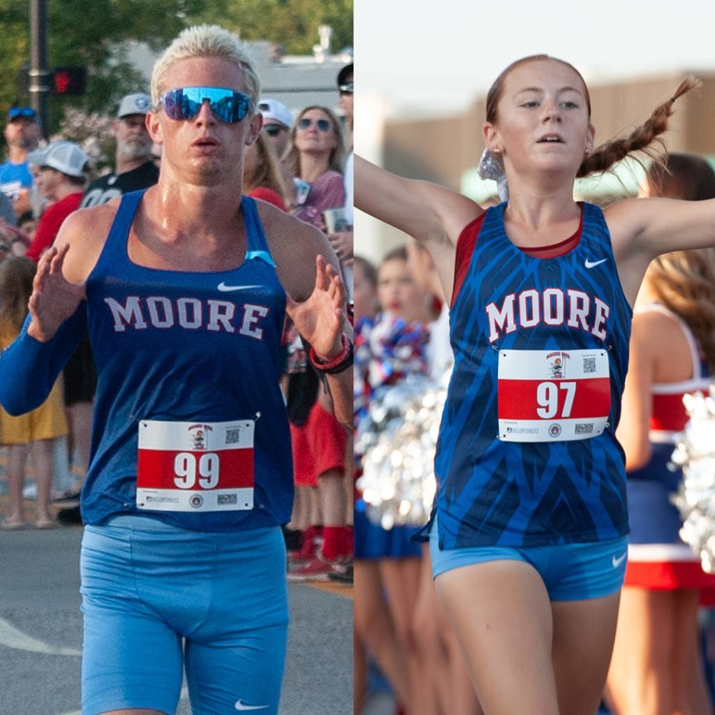 Two runners wearing Moore High School singlets and race bibs cross the finish line in 2025
